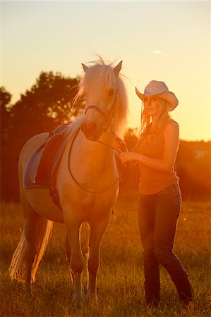 simsearch:853-06306120,k - Young woman with horse on meadow in backlight Stock Photo - Rights-Managed, Code: 853-06442128