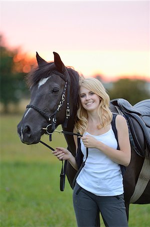 simsearch:853-06306120,k - Smiling woman with horse on meadow Stock Photo - Rights-Managed, Code: 853-06442129