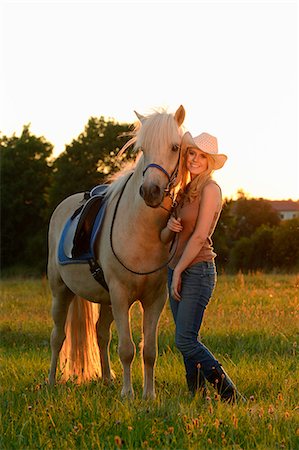 simsearch:853-06306120,k - Smiling woman with horse on meadow Stock Photo - Rights-Managed, Code: 853-06442121