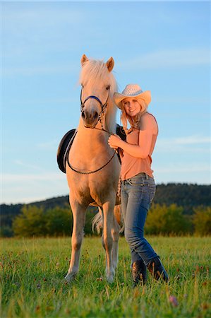 simsearch:853-06306120,k - Smiling woman with horse on meadow Stock Photo - Rights-Managed, Code: 853-06442134