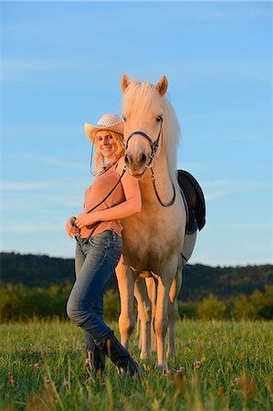 simsearch:853-06306120,k - Smiling woman with horse on meadow Stock Photo - Rights-Managed, Code: 853-06442136