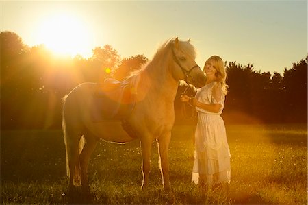simsearch:853-06306120,k - Smiling woman in white dress with horse on meadow Stock Photo - Rights-Managed, Code: 853-06442137