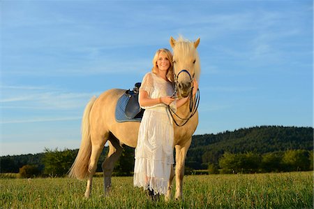 simsearch:853-06306120,k - Smiling woman in white dress with horse on meadow Stock Photo - Rights-Managed, Code: 853-06442146