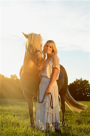 simsearch:853-06306120,k - Smiling woman in white dress with horse on meadow Stock Photo - Rights-Managed, Code: 853-06442147