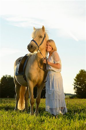 simsearch:853-06306120,k - Smiling woman in white dress with horse on meadow Stock Photo - Rights-Managed, Code: 853-06442140