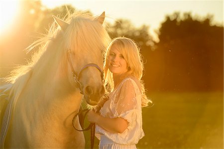 simsearch:853-06306120,k - Smiling woman in white dress with horse on meadow Stock Photo - Rights-Managed, Code: 853-06442141