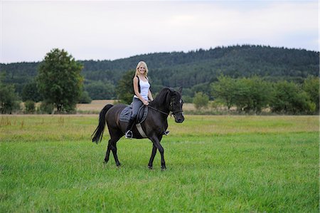 day - Smiling woman riding Stock Photo - Rights-Managed, Code: 853-06442159