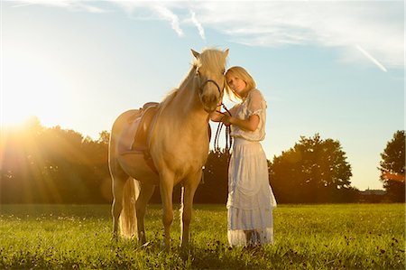simsearch:853-06306120,k - Smiling woman in white dress with horse on meadow Stock Photo - Rights-Managed, Code: 853-06442166