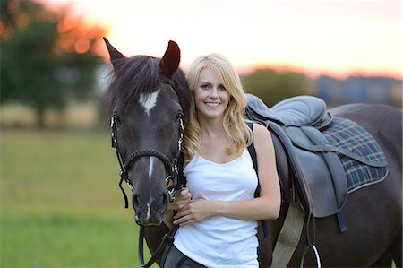 simsearch:853-06306120,k - Smiling woman with horse on meadow Stock Photo - Rights-Managed, Code: 853-06442169