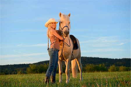simsearch:853-06306120,k - Smiling woman with horse on meadow Stock Photo - Rights-Managed, Code: 853-06442162