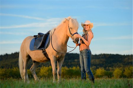 simsearch:853-06306120,k - Smiling woman with horse on meadow Stock Photo - Rights-Managed, Code: 853-06442163