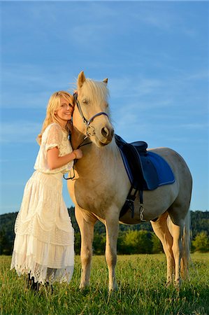 simsearch:853-06306120,k - Smiling woman in white dress with horse on meadow Stock Photo - Rights-Managed, Code: 853-06442174