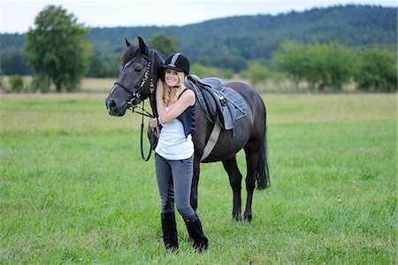 simsearch:853-06306120,k - Smiling woman with horse on meadow Stock Photo - Rights-Managed, Code: 853-06442177