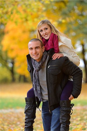 riding boots not equestrian not cowboy not child - Man carrying woman piggyback in autumnal landscape Stock Photo - Rights-Managed, Code: 853-06442253