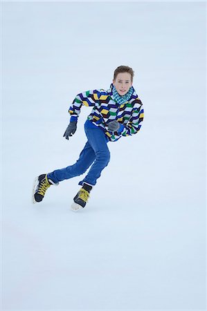 Boy ice-skating on a frozen lake Stock Photo - Rights-Managed, Code: 853-06893160