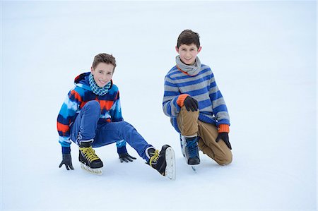 Two boys with ice-skates on a frozen lake Stock Photo - Rights-Managed, Code: 853-06893175