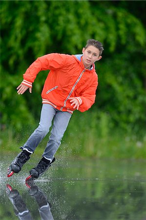 pre teen rollerblading - Boy with in-line skates on a rainy day Stock Photo - Rights-Managed, Code: 853-07148623