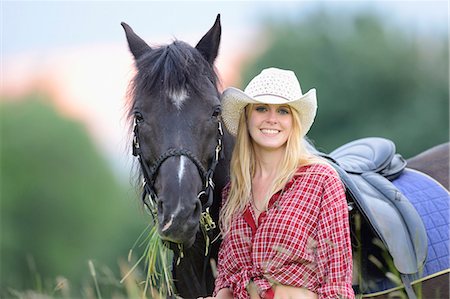 reins - Young woman standing beside a horse on a meadow, portrait Stock Photo - Rights-Managed, Code: 853-07148631