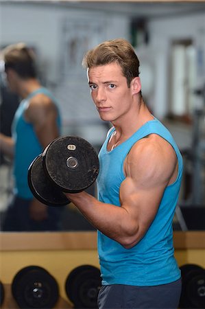 Young man exercising in fitness center Stock Photo - Rights-Managed, Code: 853-07241921