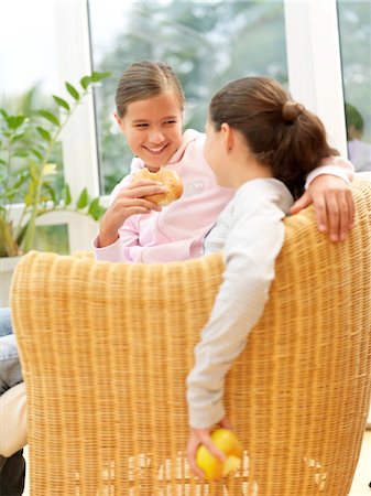 Two girls sitting in armchair Stock Photo - Rights-Managed, Code: 853-02914035