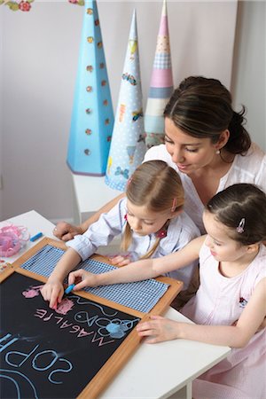 Mother and children writing on blackboard Stock Photo - Rights-Managed, Code: 853-02914355