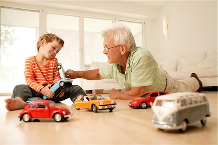 Grandfather and grandson playing with cars Stock Photo - Rights-Managed, Code: 853-02913671
