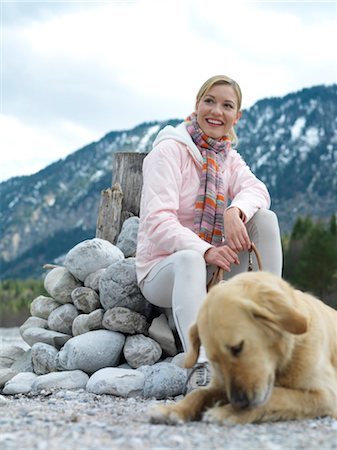 Woman sitting with dog at lake Stock Photo - Rights-Managed, Code: 853-02913779