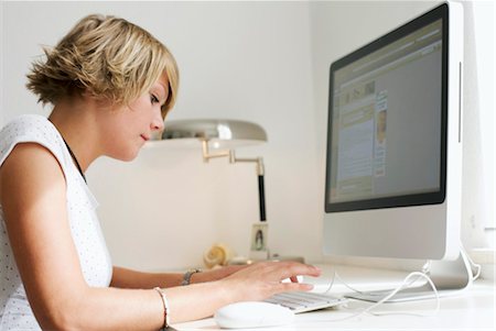 Young woman using desktop computer, side view Stock Photo - Rights-Managed, Code: 853-03458843