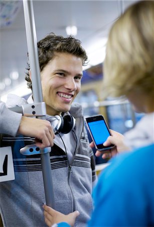 flirting - Young man flirting with girl in metro, slanted view Stock Photo - Rights-Managed, Code: 853-03458859