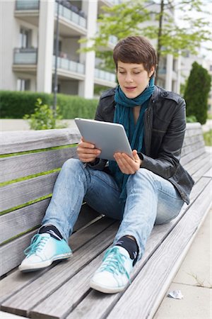 Young woman using iPad on a bench Stock Photo - Rights-Managed, Code: 853-03616855