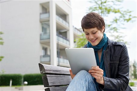 people sitting on bench - Young woman using iPad on a bench Stock Photo - Rights-Managed, Code: 853-03616852
