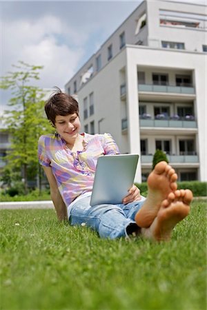Young woman using iPad in grass Stock Photo - Rights-Managed, Code: 853-03616869