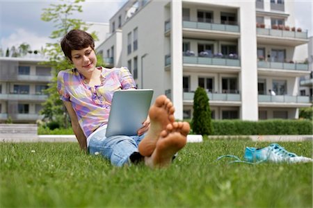 Young woman using iPad in grass Stock Photo - Rights-Managed, Code: 853-03616870