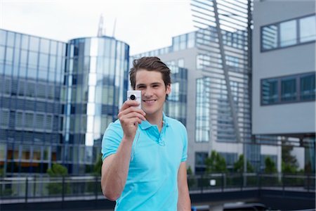 polo shirt - Young man with smartphone in front of office building Stock Photo - Rights-Managed, Code: 853-03616891