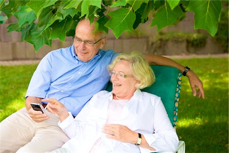 Happy senior couple with smartphone in garden Stock Photo - Rights-Managed, Code: 853-03616967