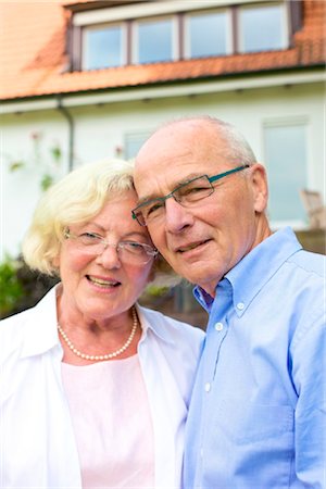 pension - Happy senior couple in front of residential building, portrait Stock Photo - Rights-Managed, Code: 853-03616968