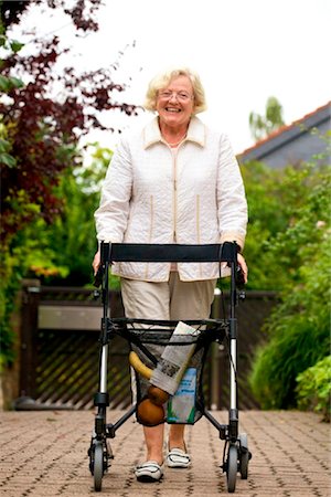 Senior woman with walking frame making purchases Stock Photo - Rights-Managed, Code: 853-03616982