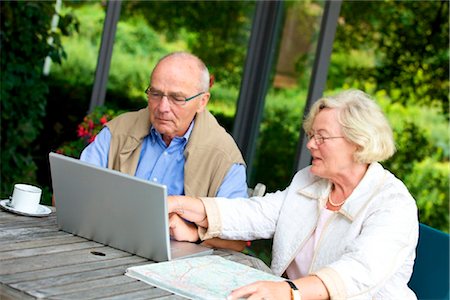 Senior couple on terrace with laptop and road map Stock Photo - Rights-Managed, Code: 853-03616991