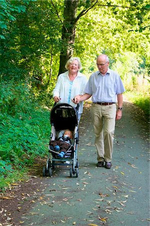 Grands-parents se promener avec petit-fils en poussette Photographie de stock - Rights-Managed, Code: 853-03617033