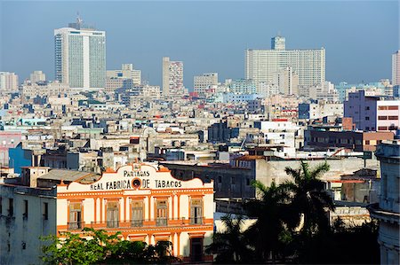 The Caribbean, West Indies, Cuba, Central Havana, Real Fabrica de Tabacas Partagas Tobacco Factory and city view Stock Photo - Rights-Managed, Code: 862-05997381