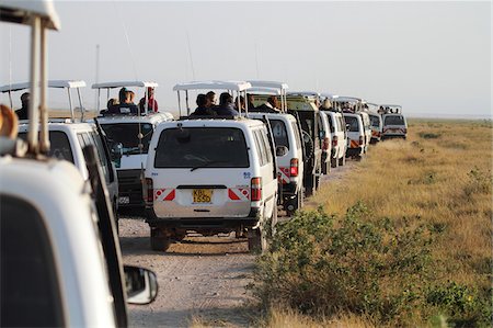 people in traffic jam - Safari minibus traffic jam in Amboseli National Park, Kenya. Big cat sightings often cause vehicle conjestion in popular parks like Amboseli. Stock Photo - Rights-Managed, Code: 862-05998376