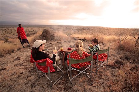 safari - A family enjoys drinks at sunset on safari in Elerai Conservancy, near Amboseli National Park, Kenya. Stock Photo - Rights-Managed, Code: 862-05998371