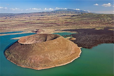 The perfectly shaped volcanic cone called Nabuyatom juts into the jade waters of Lake Turkana. Stock Photo - Rights-Managed, Code: 862-05998451