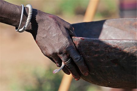 rituals - When an animal is speared during a Pokot Sapana ceremony some of its blood will be collected in a wooden bowl to mix with milk later in the ritual. Stock Photo - Rights-Managed, Code: 862-05998501