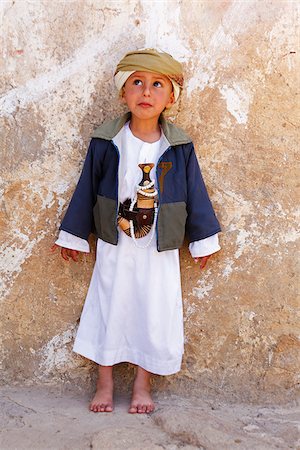 Yemen, Sana'a Province, Haraz Mountains, Al Hajjarah. A boy stands against a wall. Stock Photo - Rights-Managed, Code: 862-05999735