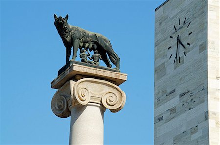 Europe, Italy, Aosta Valley,  Aosta, statue of a wolf and clock tower Stock Photo - Rights-Managed, Code: 862-06541975