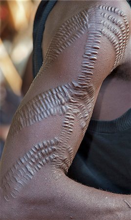simsearch:862-03888708,k - A Pokot man with scarification on his right arm.  This form of body art is quite common among his tribe. The cicatrices are raised by rubbing charcoal or the sap of a plant into them when the wounds are still fresh. Stock Photo - Rights-Managed, Code: 862-06542266