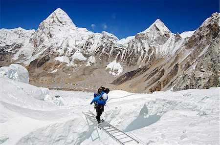 Asia, Nepal, Himalayas, Sagarmatha National Park, Solu Khumbu Everest Region, the Khumbu icefall on Mt Everest, climbers crossing ladders over a crevasse Stock Photo - Rights-Managed, Code: 862-06542440