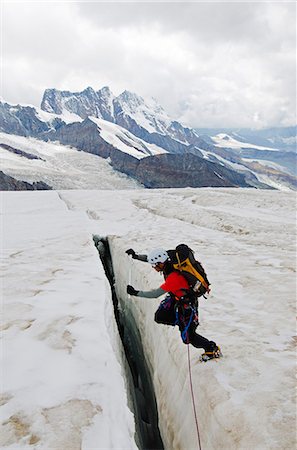 Europe, Switzerland, Swiss Alps, Valais, Zermatt, climber crossing a crevase on Monte Rosa , MR, Stock Photo - Rights-Managed, Code: 862-06543078