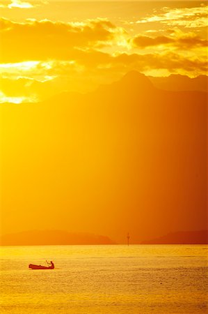 picture of a person on a tropical island - Brazil, Rio de Janeiro State, Angra dos Reis, Ilha Grande, a fisherman silhouetted against the sunset over the Costa Verde, Green Coast, Stock Photo - Rights-Managed, Code: 862-06675709